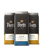 Three Peet's coffee bags with different roast labels on a black background