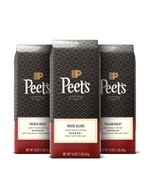 Three Peet's coffee bags with different roast types on a black background